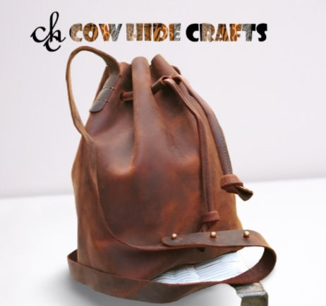 Drawstring lace closure on brown distressed leather bucket bag
