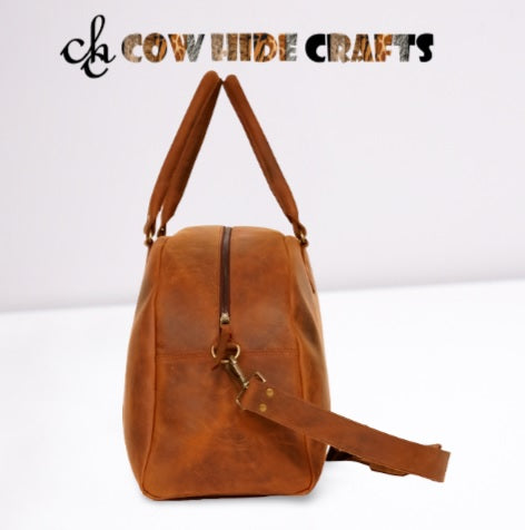 Dual handles and detachable strap on leather weekender duffle