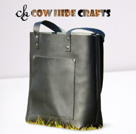 Dual handles and outside pocket on black leather tote bag