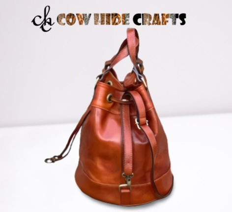 Dual handles and strap on leather drawstring bucket bag