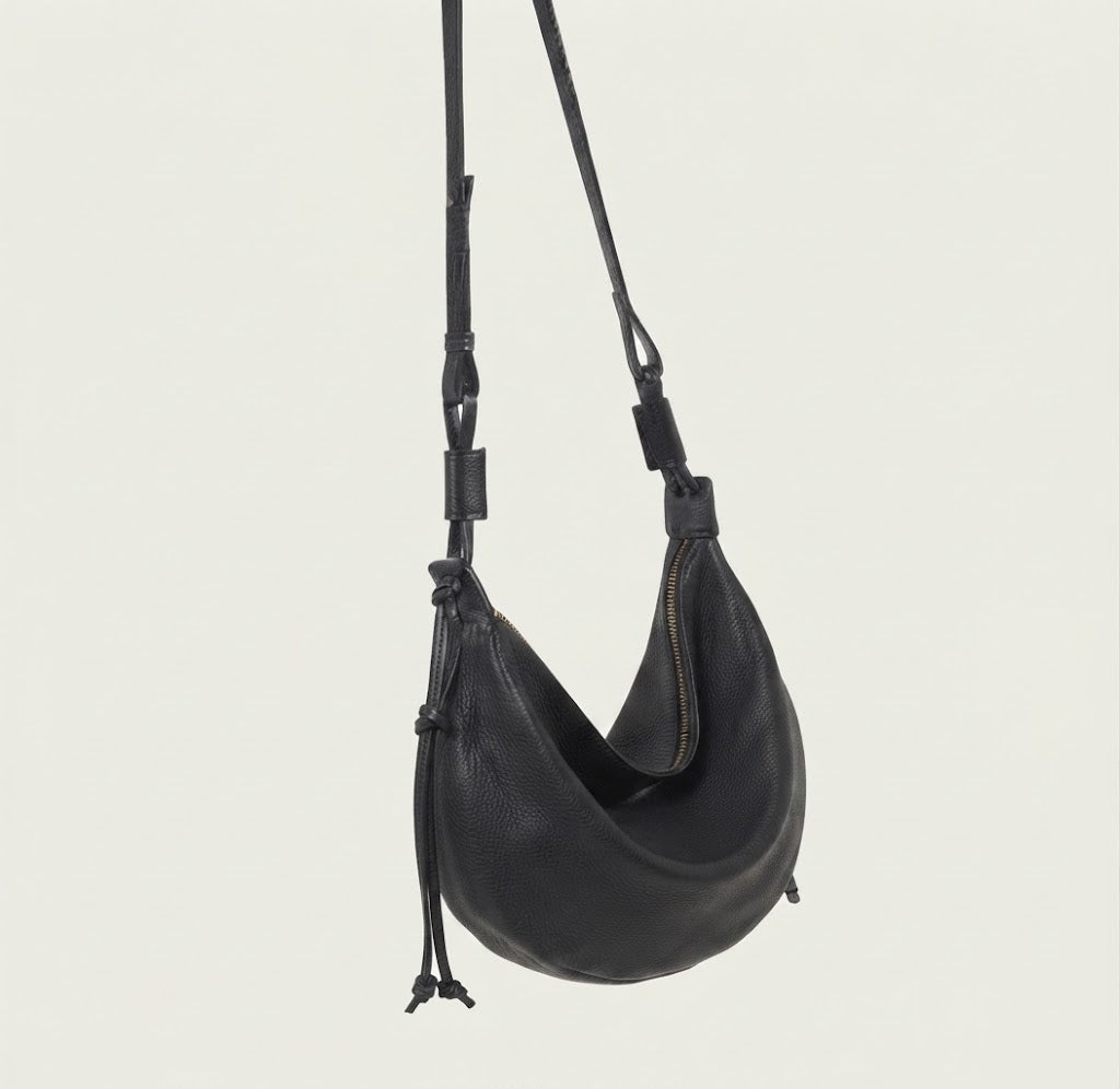 Knotted leather strap loop detail on dumpling crescent bag