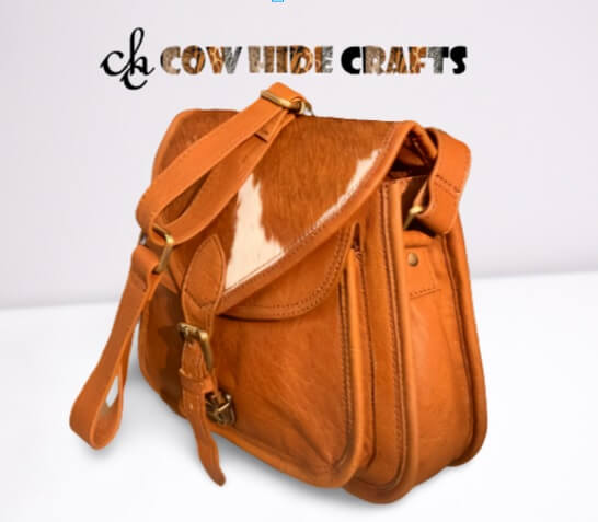 Flap closure cowhide messenger bag tan white