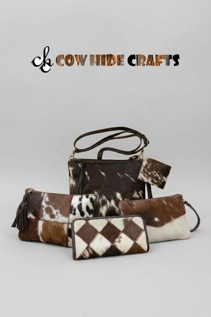 Rectangular dark brown and white cowhide crossbody bag with leather fringe zipper pull and mini coin pouch.