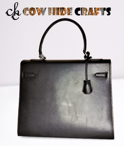 Hard firm briefcase structure detail on black leather box bag