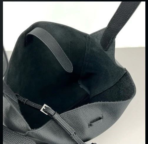 Interior toggle strap adjustment detail on slouchy hobo bag
