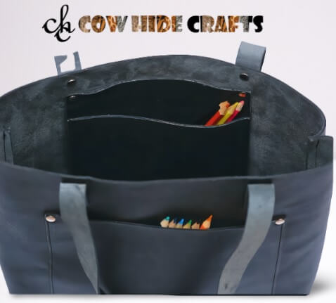 Inside pocket detail on black leather luxury tote handbag