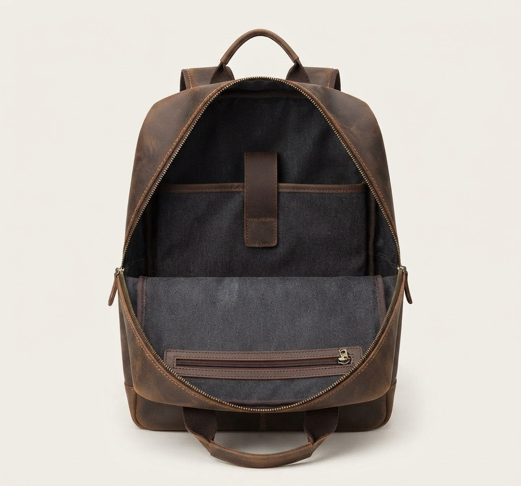 Padded laptop sleeve interior of leather travel backpack