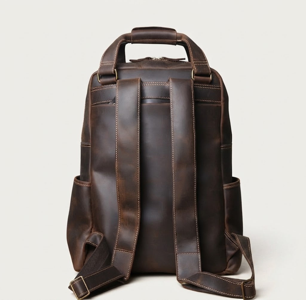 Adjustable contoured shoulder strap detail on leather backpack