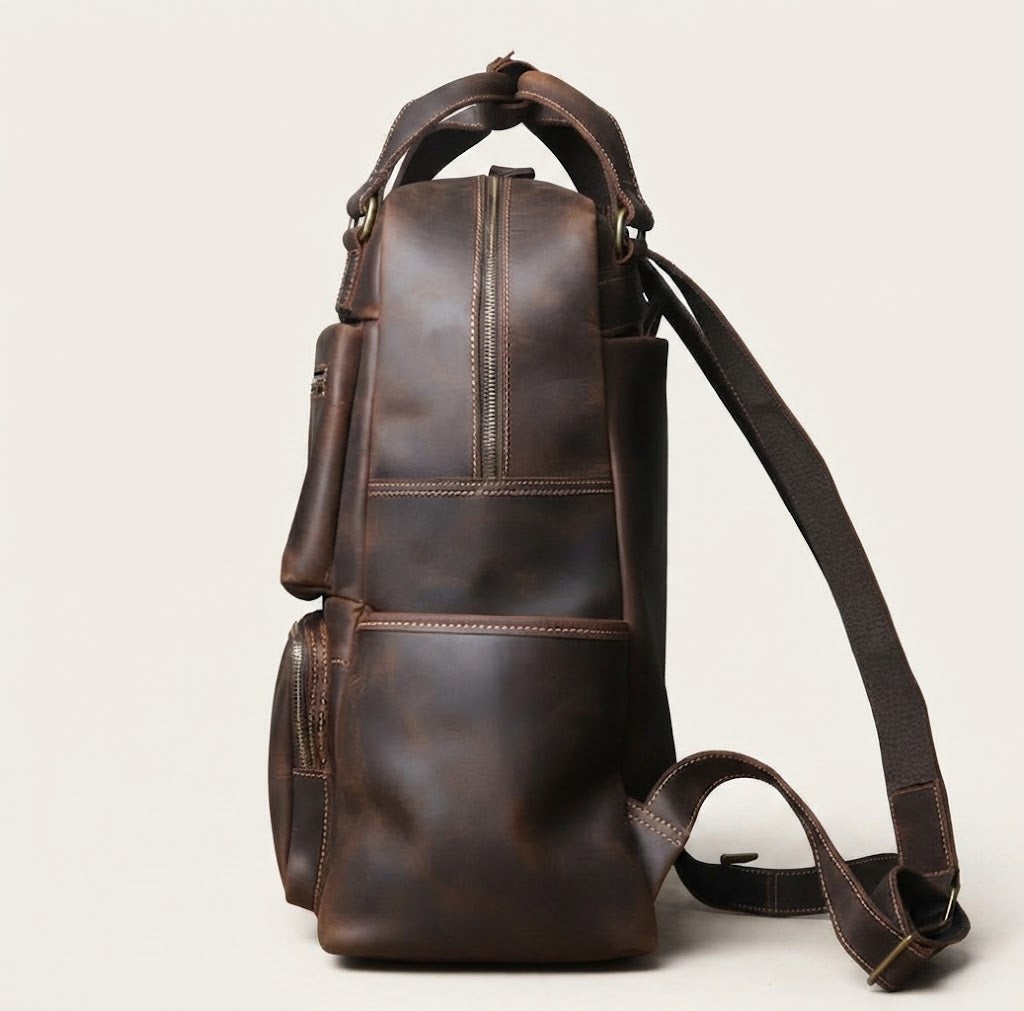 Stacked front zippered pocket detail on leather travel backpack