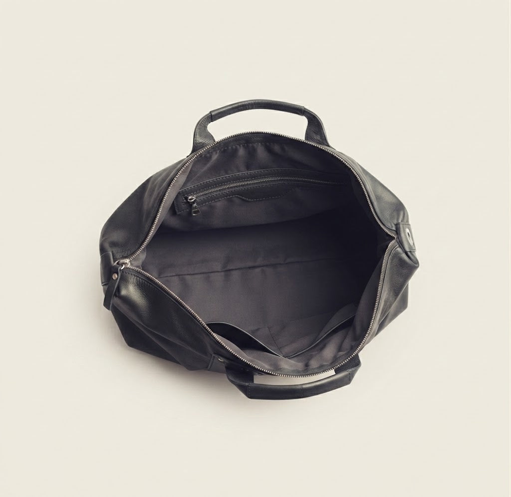 Discrete side zip access detail on leather duffle backpack