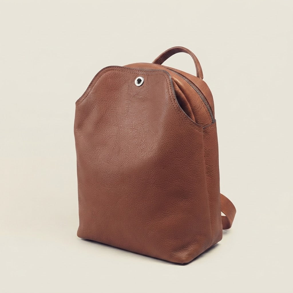 Leather flap backpack with turn-lock closure in tan