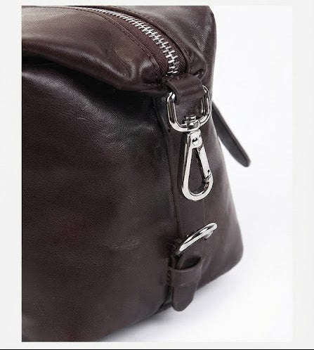 Adjustable strap buckle detail on leather mini duffle bag