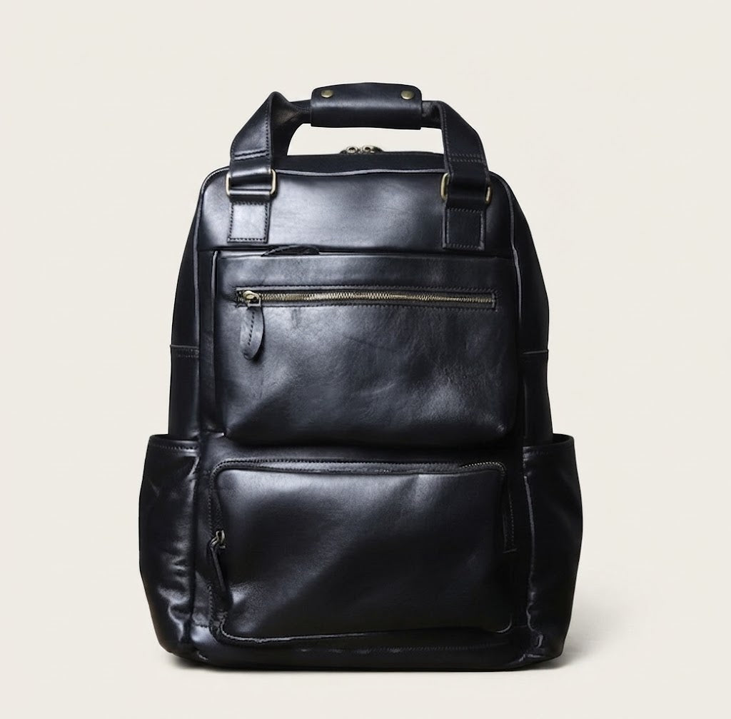 Leather travel backpack in black colorway front view