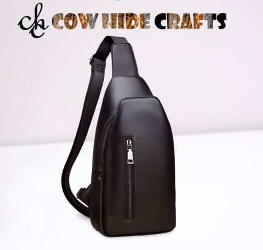 Main zipper and front pockets on black leather sling bag