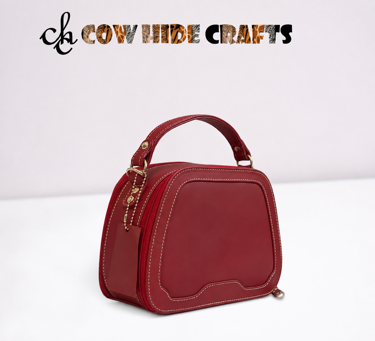 Maroon leather bag curved top dual zipper structured