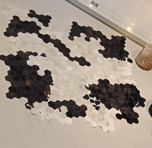 Organic honeycomb cowhide rug jagged natural edge pattern