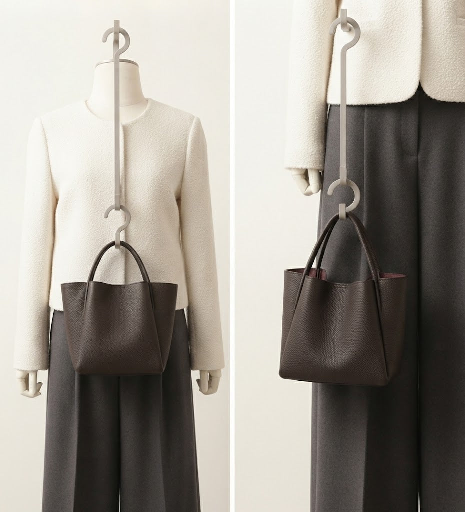 Magnetic snap closure detail on pebbled leather bucket tote