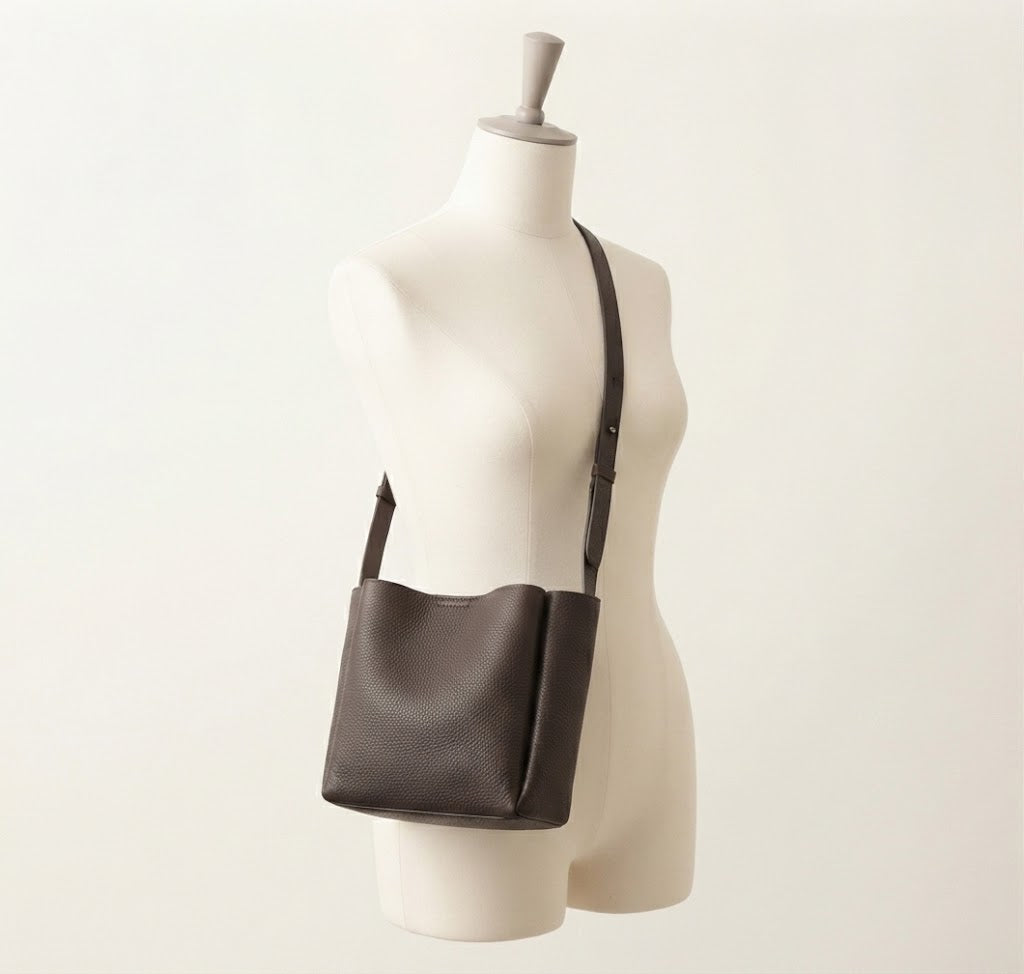 Convertible strap detail on pebbled leather bucket tote