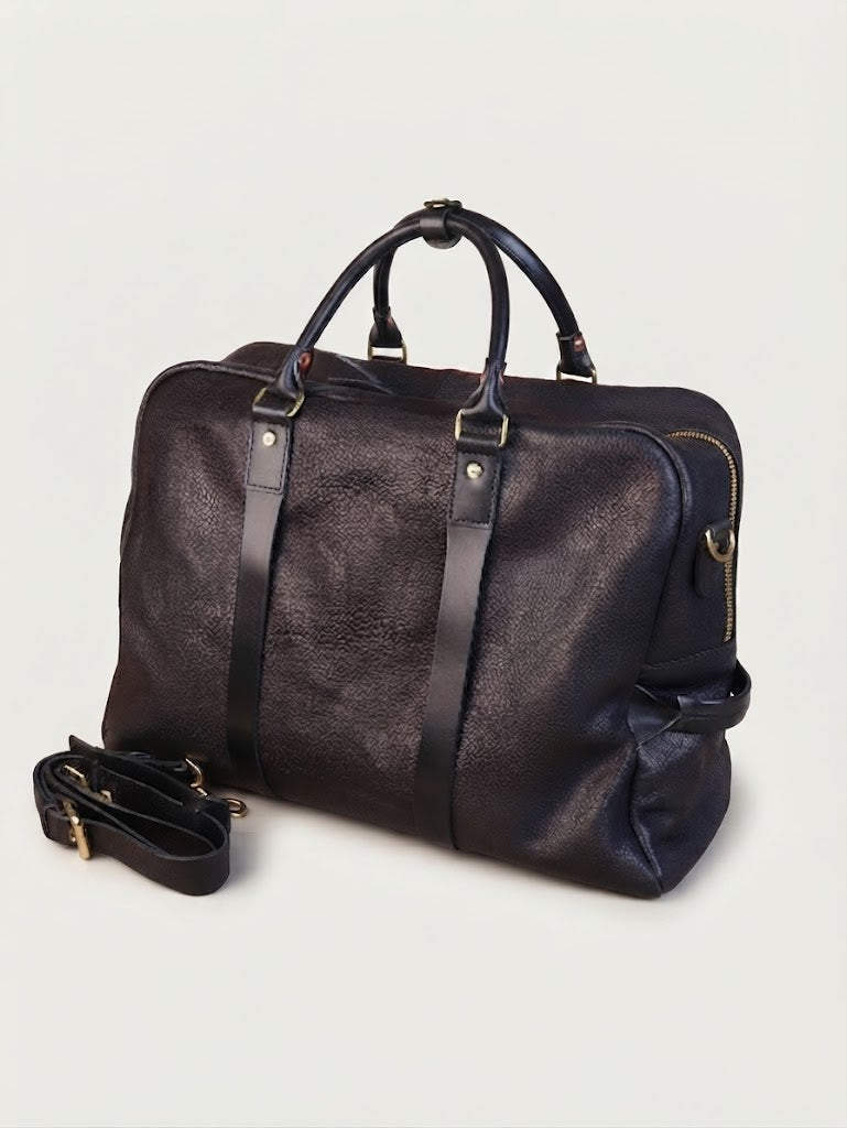 Leather grab loop detail on pebbled leather weekender bag