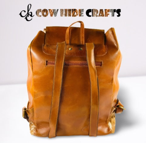 Tan and white cowhide backpack