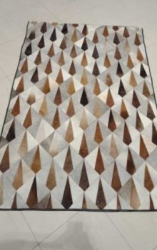 Spiked patchwork cowhide rug brown white