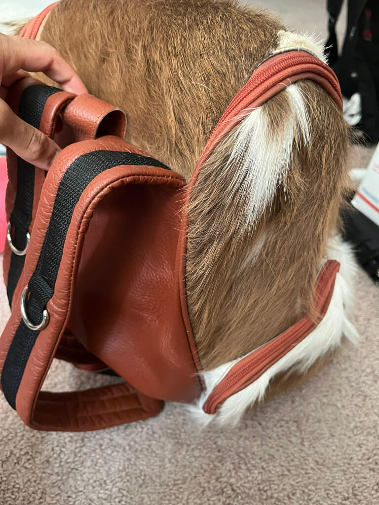 Tan cowhide backpack elastic slit interior pockets