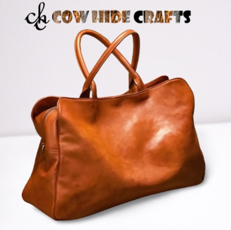 Tan leather slouchy duffle bag with shoulder strap