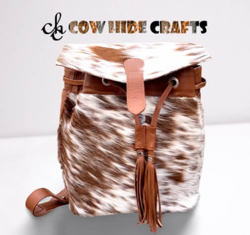Tan and white cowhide backpack