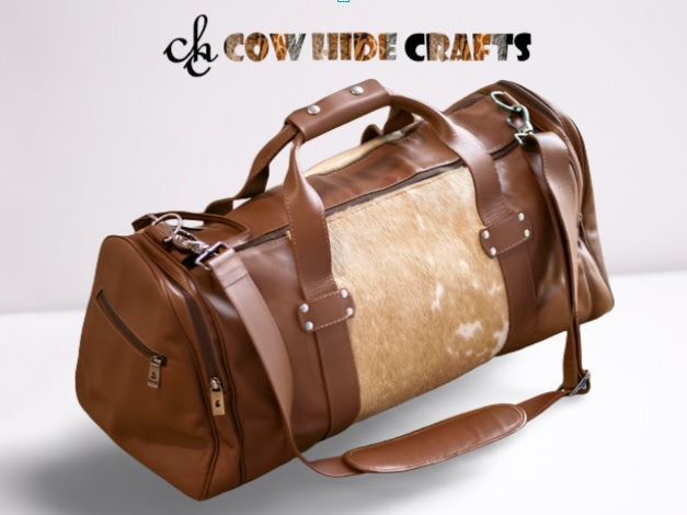 tan and white cowhide duffle bag