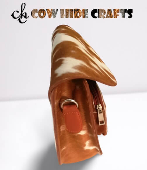 Tan white cowhide flap clutch side view