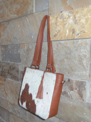 Tan white cowhide medium handbag side view