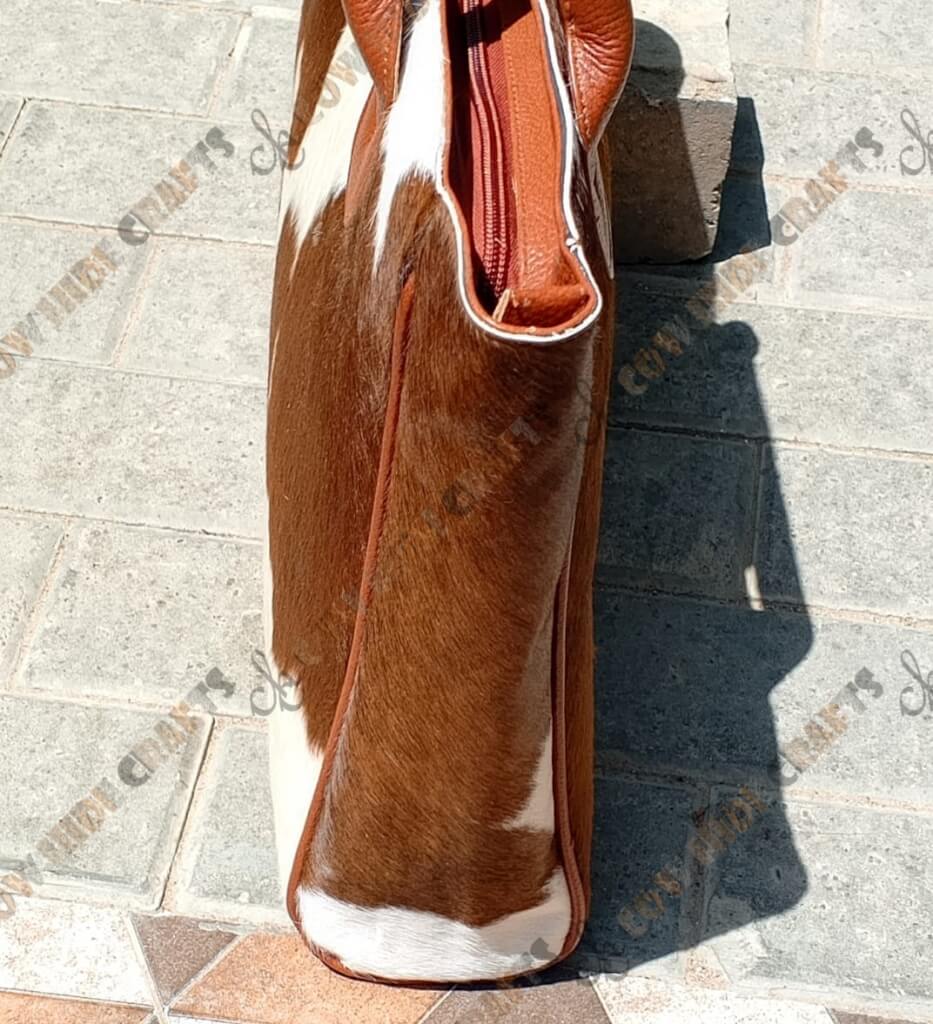 Tan white cowhide shoulder tote side view