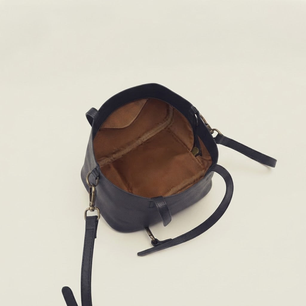 Detachable crossbody strap detail on leather vanity case bag