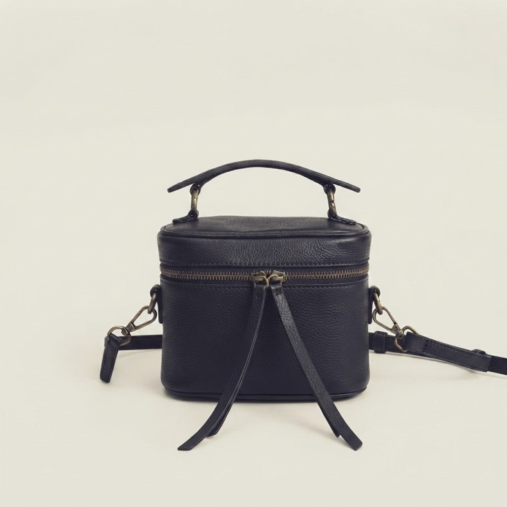 Fringe tassel zipper pull detail on leather vanity case bag