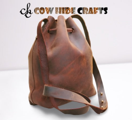 Vintage distressed leather character detail on bucket bag