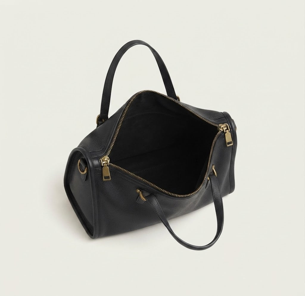 Antiqued bronze hardware detail on vintage leather satchel