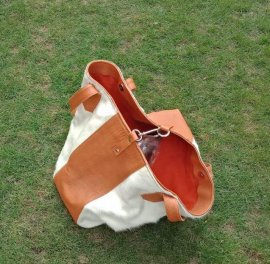 White cowhide bucket bag open top view