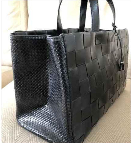 Snake-embossed side gusset detail on woven leather tote bag