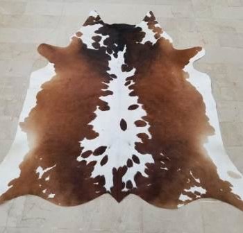 Brown and white cow rug