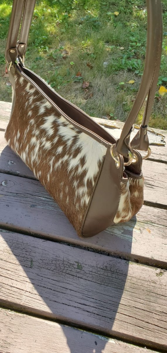 Brown and white cowhide bag