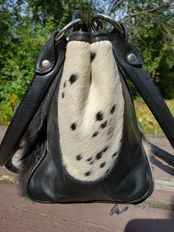 Black and white cowhide handbag.